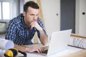 construction worker looking at pc