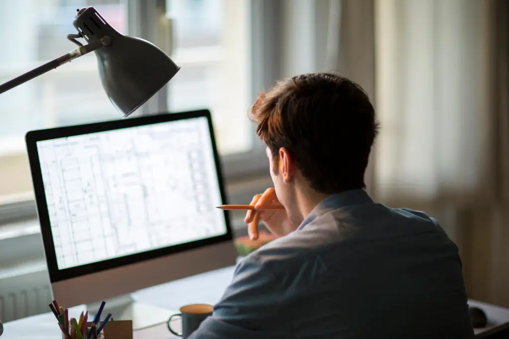 Engineer looking at drawing on computer